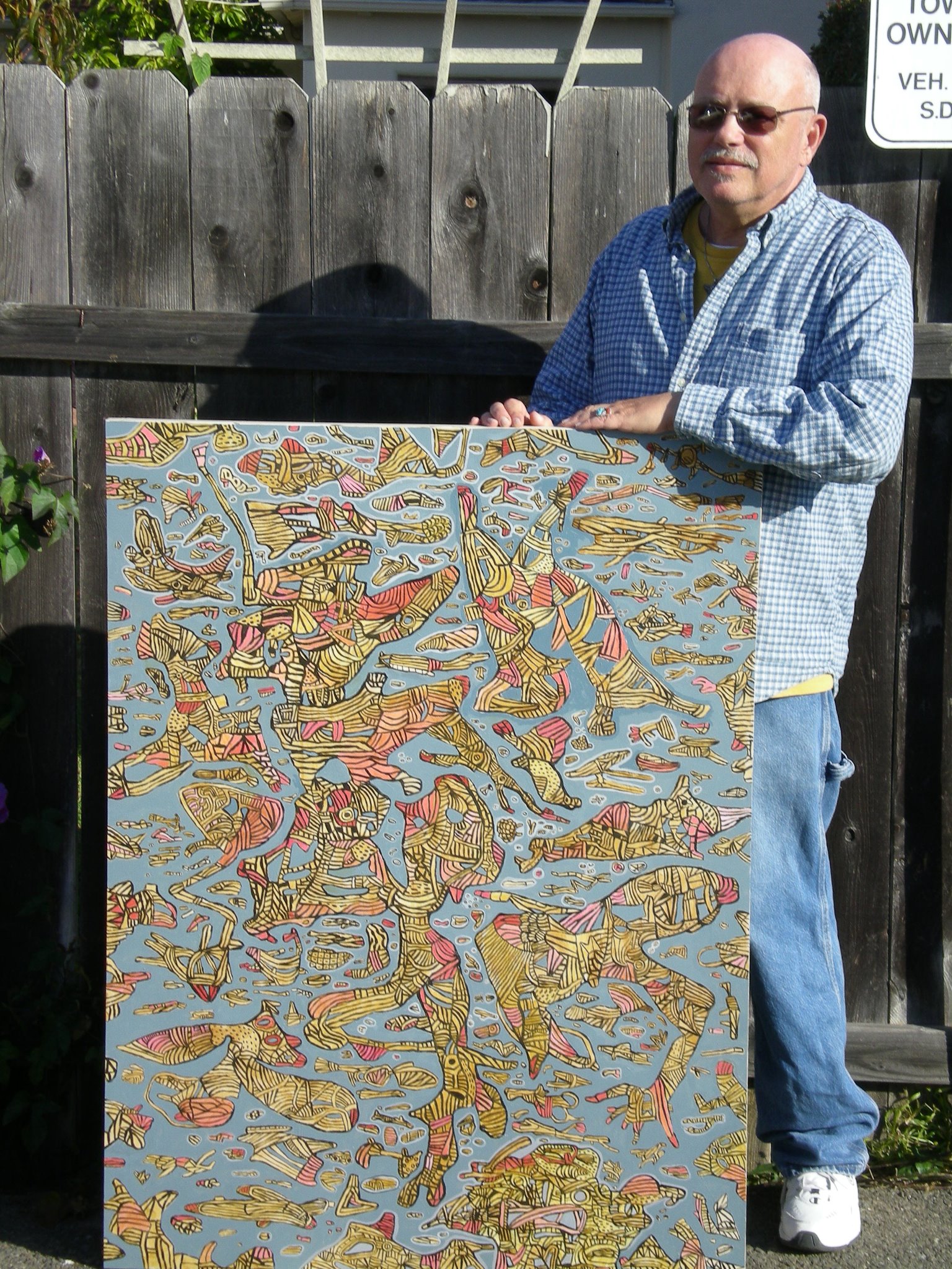 Peter holding a painting outdoors